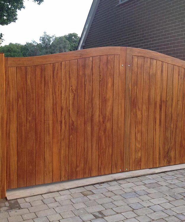 A wooden gate in front of a brick house - Patron Security Ltd