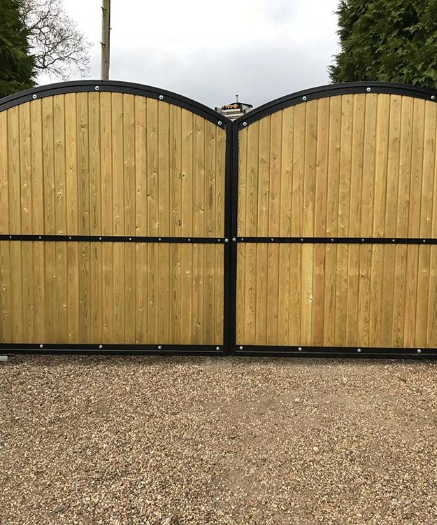 A wooden gate with a black metal frame - Patron Security Ltd