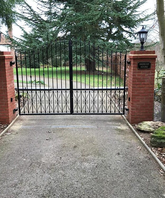 A driveway with a security gate in the middle of it - Patron Security Ltd