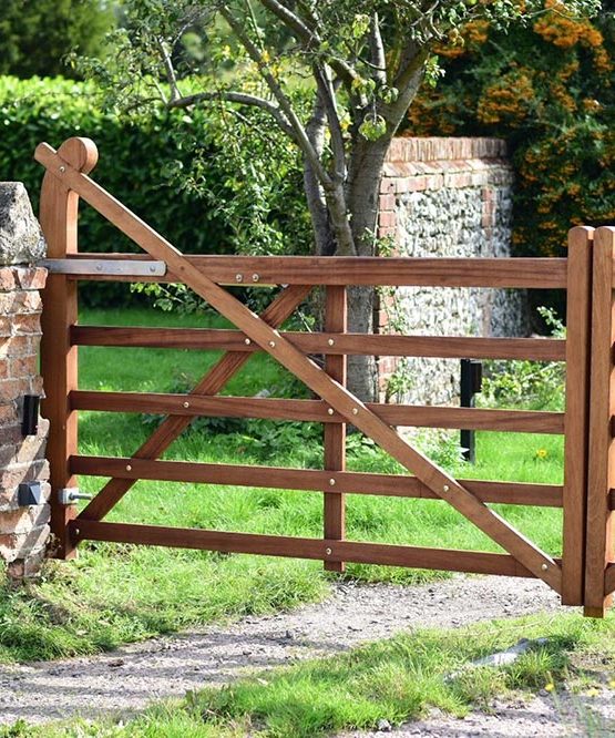 A wooden gate with a mailbox on it - Patron Security Ltd