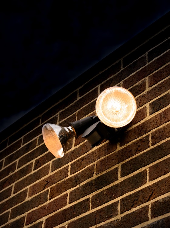 Two lights on a brick wall at night - Patron Security Ltd
